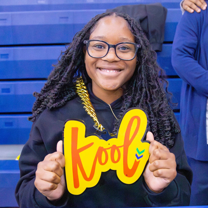 black girl wears a big kool smile while wearing kool chain