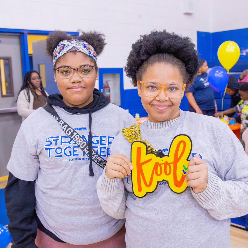 two kool attendees at community event wearing the kool chain
