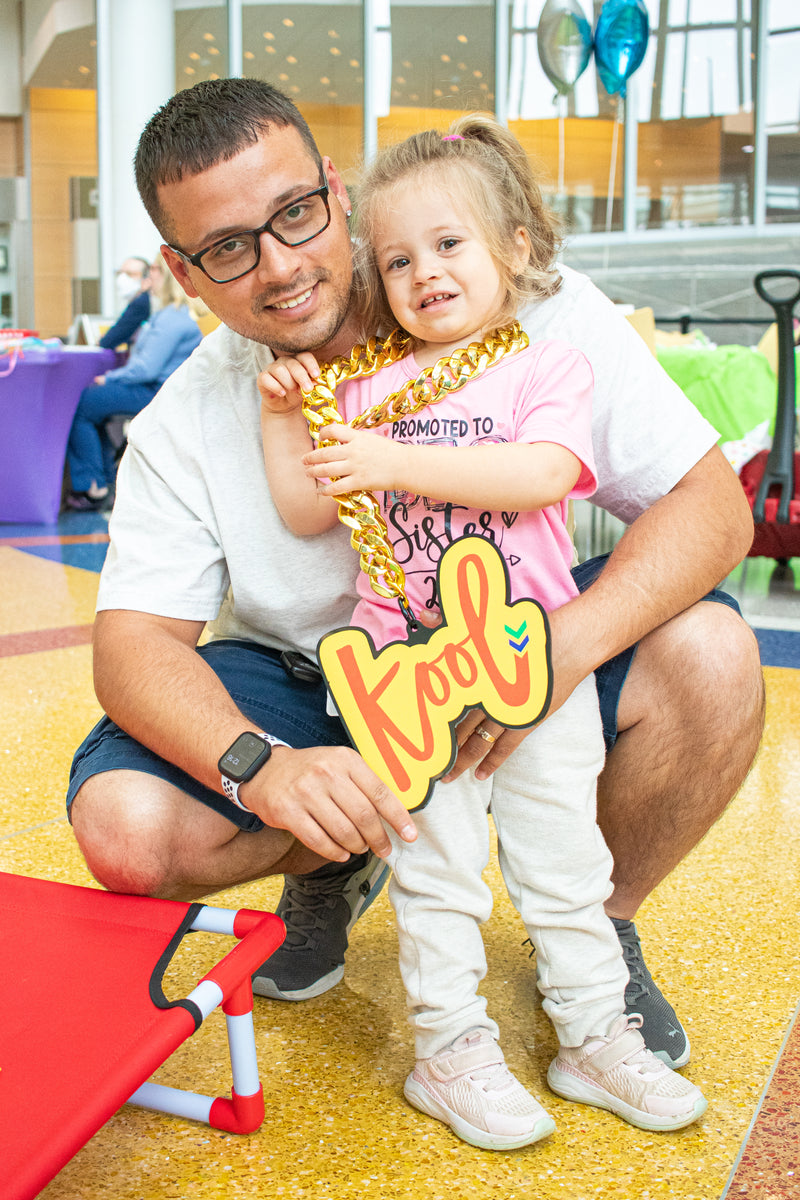 kid wears the kool chain with dad