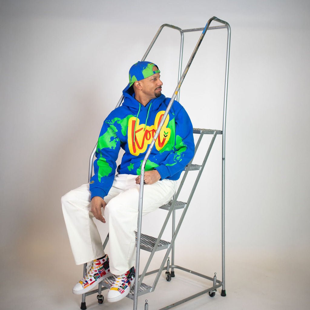 creator randall law sitting on stairs with new kool world hoodie
