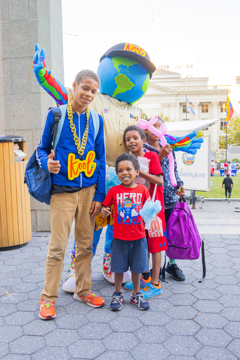kooli posing with group of kids