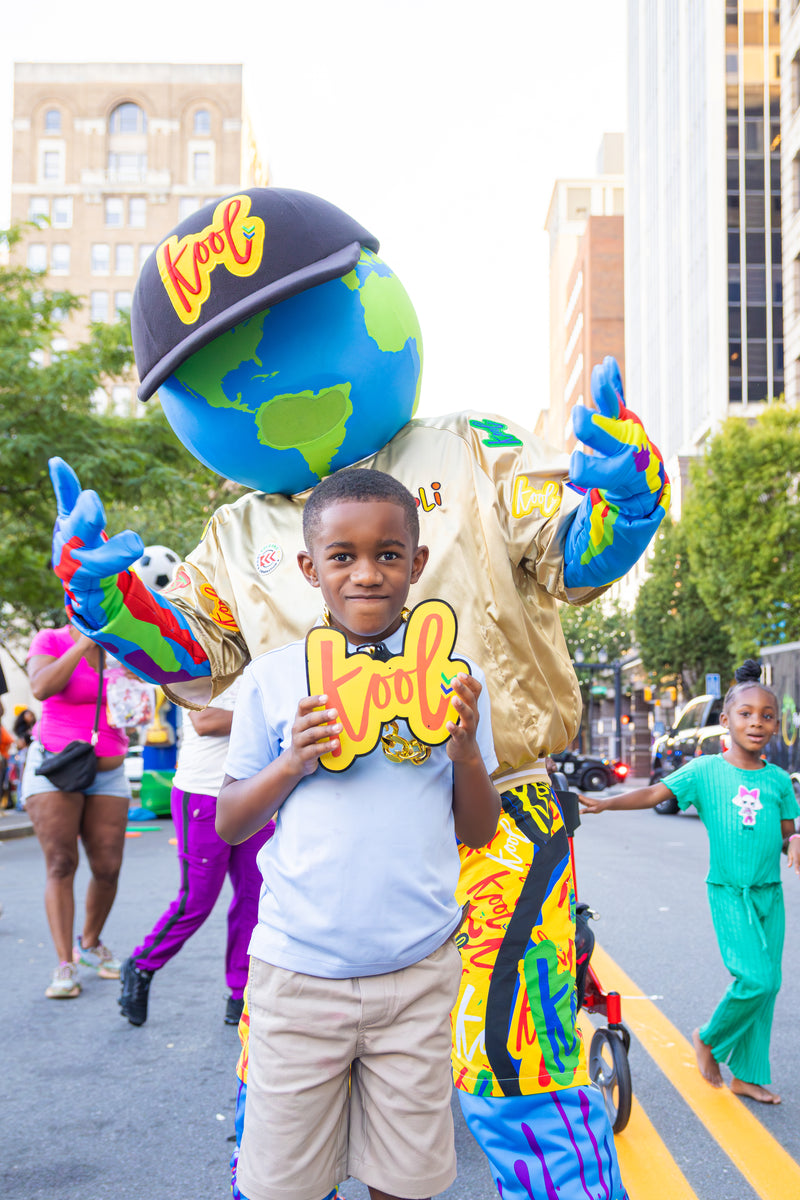 kooli posing with kid wearing the kool chain