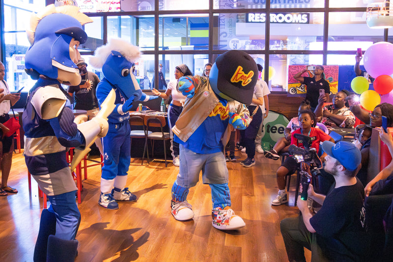 kooli dancing with a group of mascots at his birthday