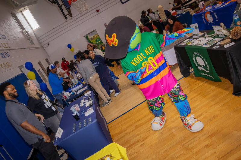 kooli making a good time dancing as guest look at colleg fair event