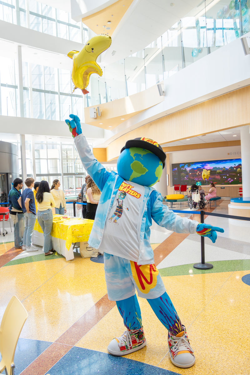 kooli flying with balloon at nemours banana party