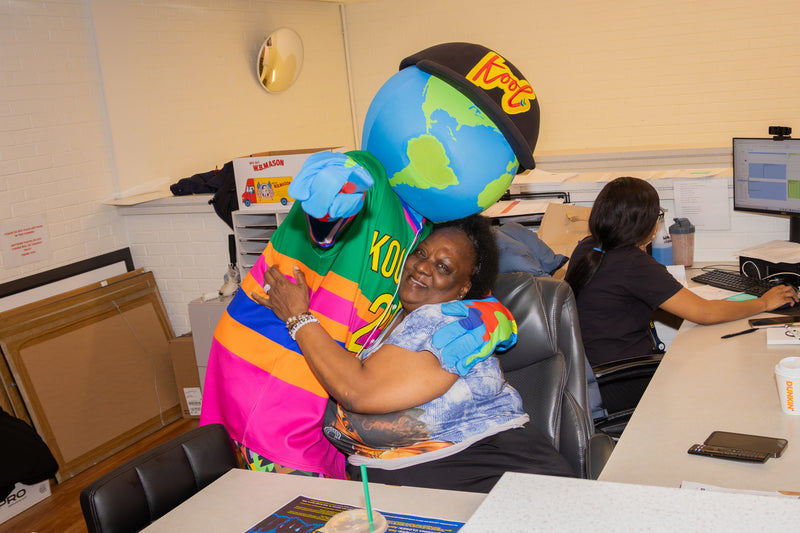 kooli hugging event worker at college fair