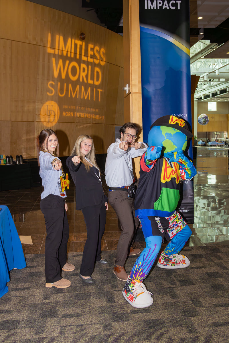 Group of people posing with kooli at the Limitless World Summit event.