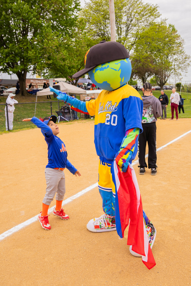 kooli high fives young player during game opener