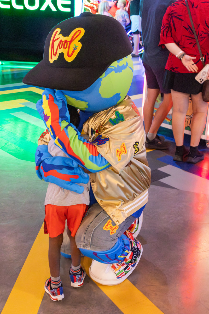 kooli hugging young child at birthday 