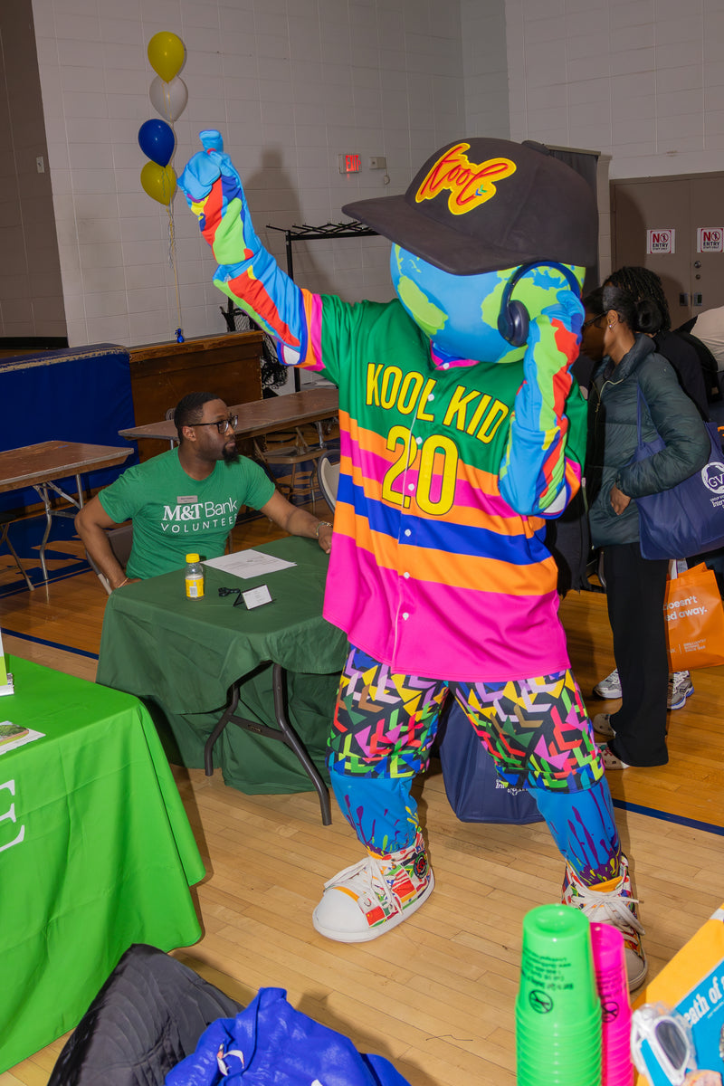 kooli rocking out to music in headset at college fair event