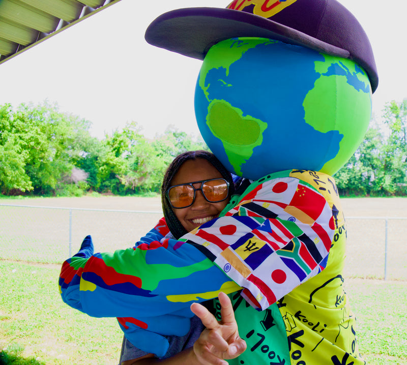 kooli gets a big hugs from attendee at summer camp during the city of wilmington pars & rec tour 2