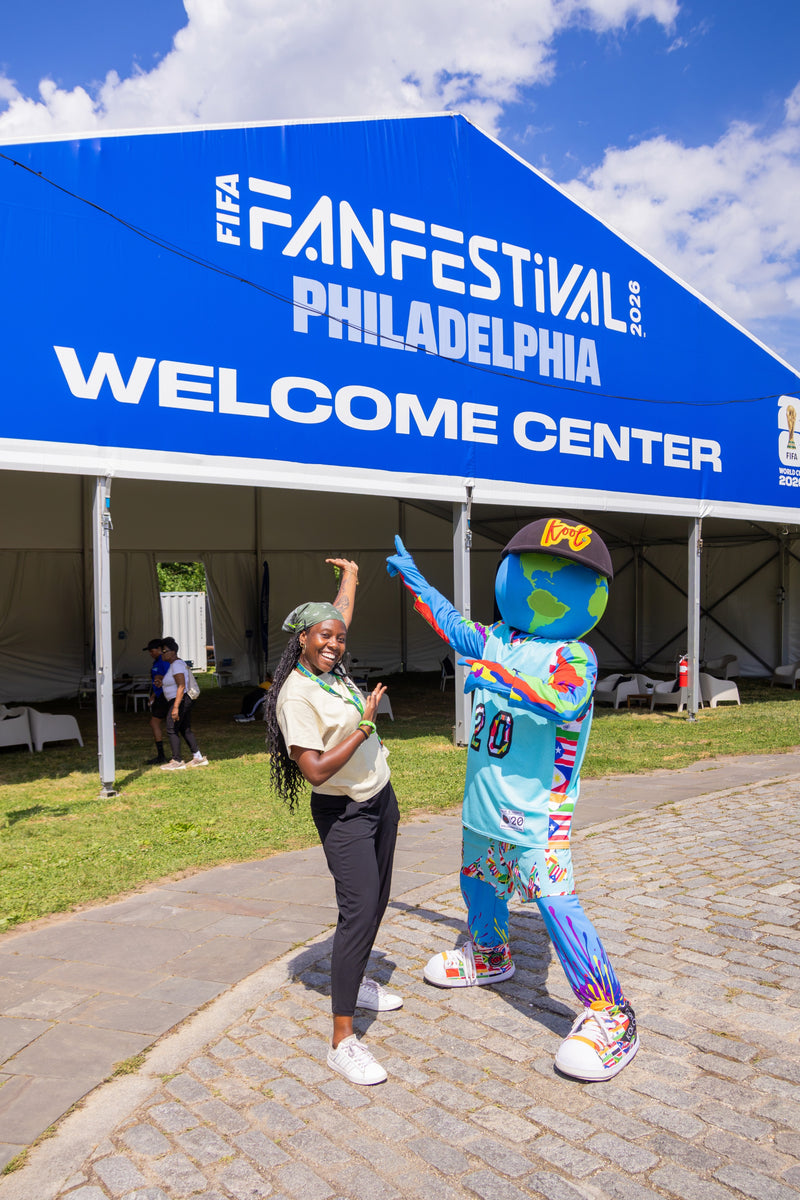 kooli stands with FIFA attendee at welcome center