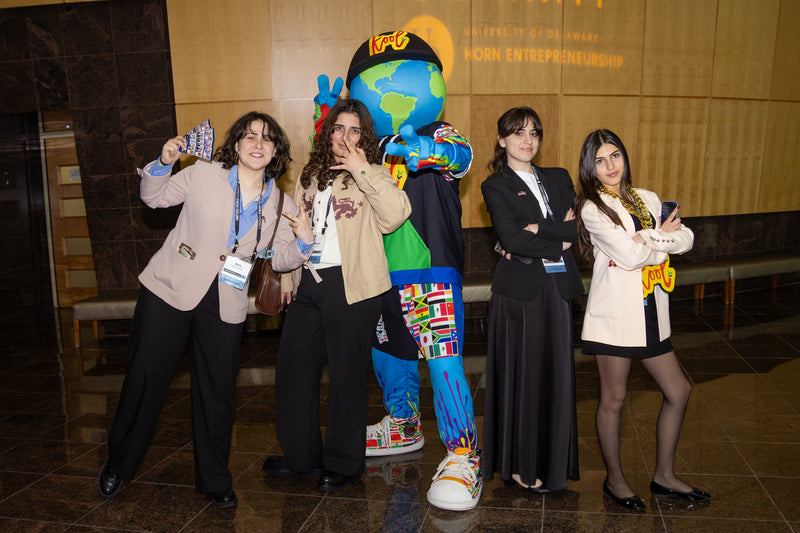 Group of people posing in front of a kooli at limitless world event