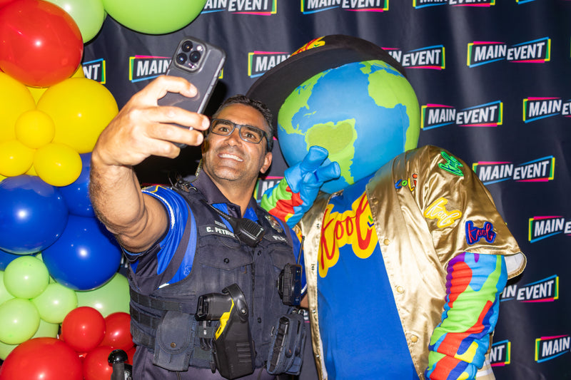 kooli taking a picture at his birthday party with cop at main event