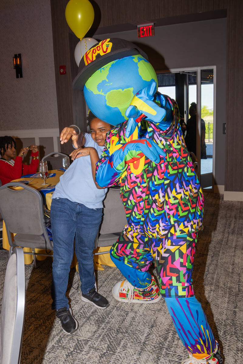 kooli interacting with student
 at an event.