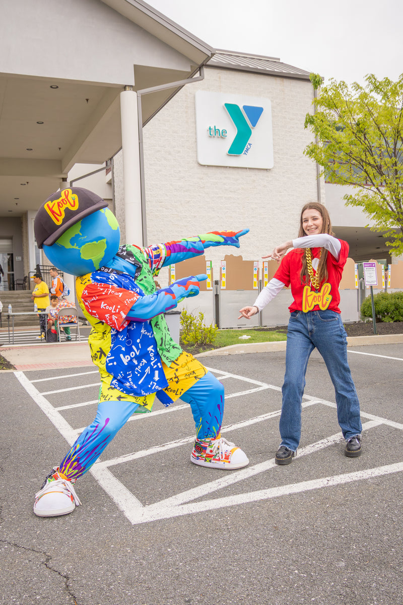 kooli and girl with kool chain share a moment at healthy kids day at the wilmington delaware ymca