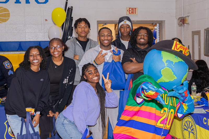 Group of teens posing with kooli at college fair event