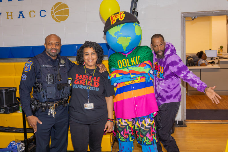 Group of people posing with kooli at college fair event