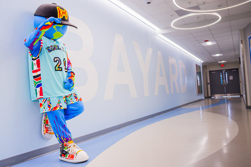 kooli takes some time to pose for a picture on the bayard school wall