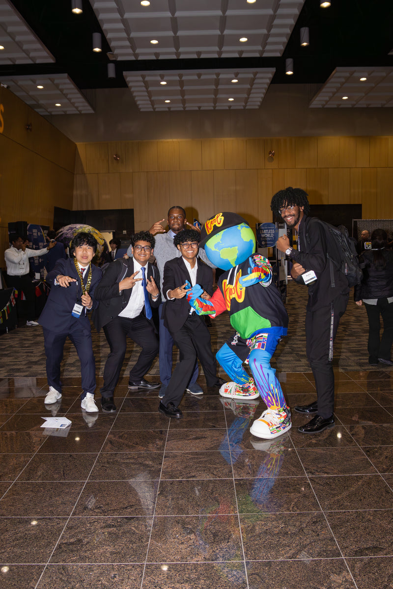 Group of people posing with kooli at the limitless world conference
