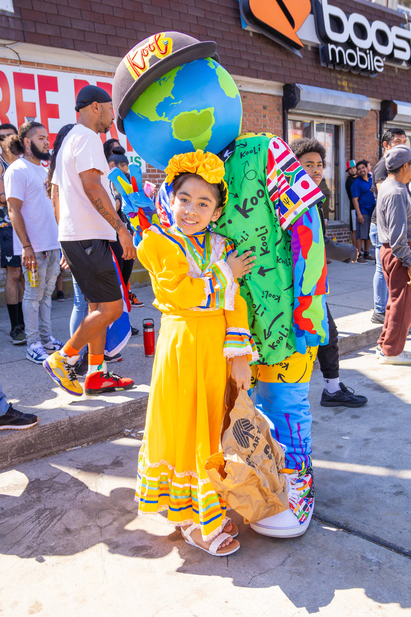 kooli posing at parade with little girl.