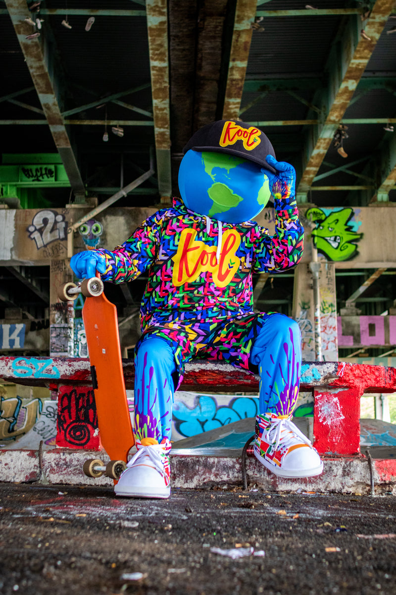 kooli sits with holding skate board