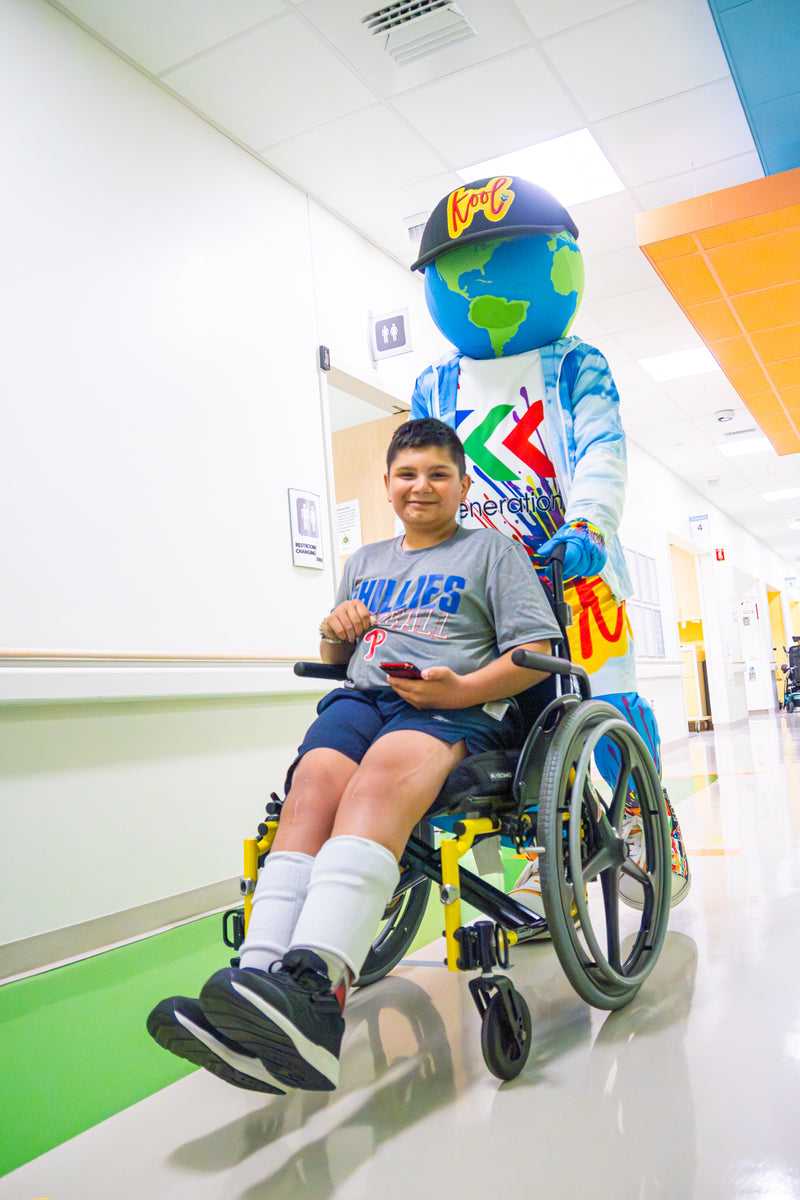 kooli wheeling patient in wheelchair at nemours hopital