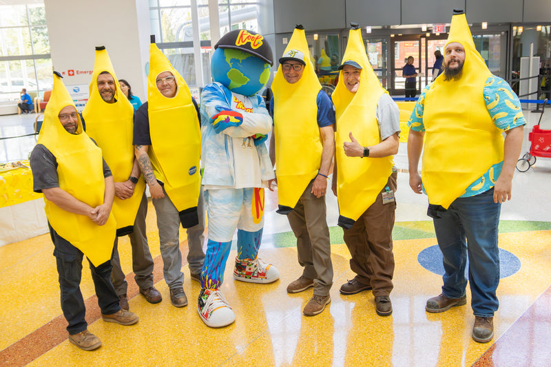kooli posing with a group of banana boys at nemours banana party