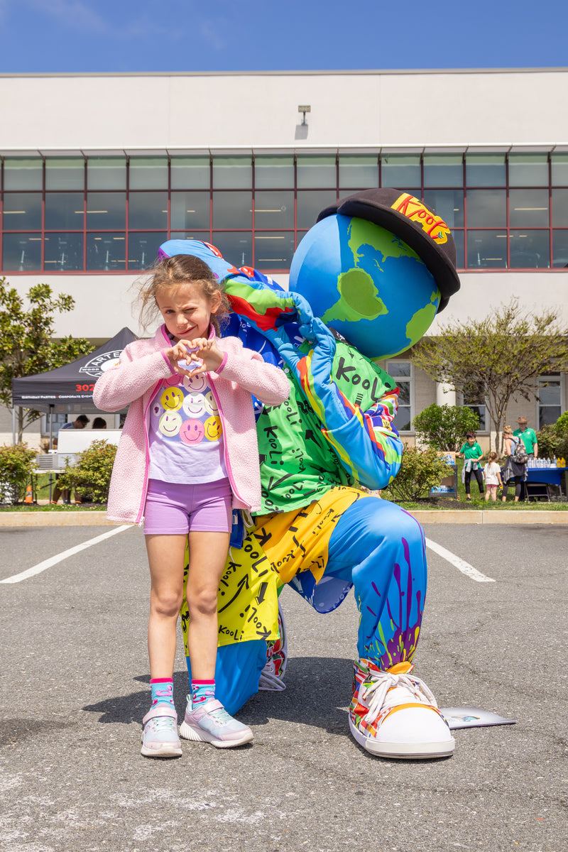 kooli shares a moment with young girl at brandywine ymca healthy kids day.