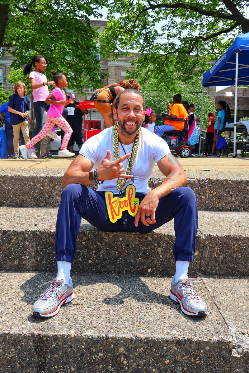man on stairs smiling with kool chain
