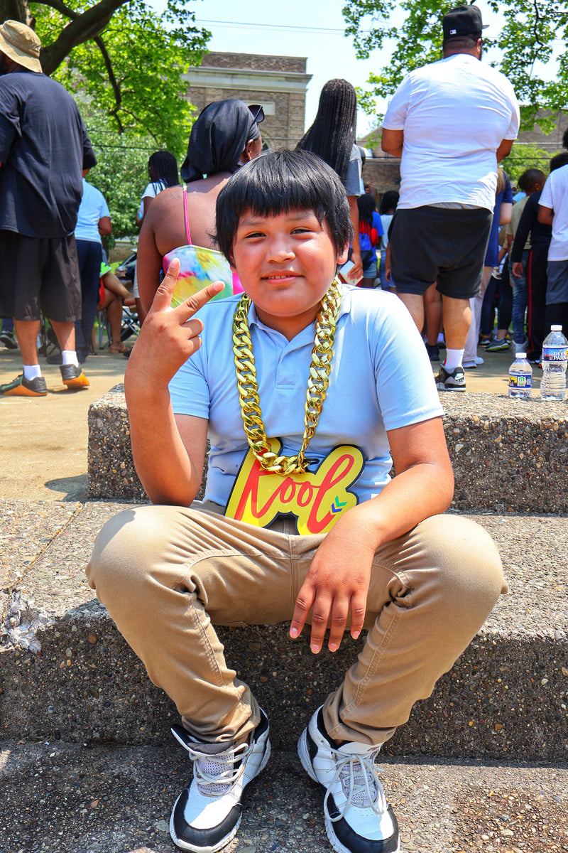 kid throws up the peace sign in kool chain