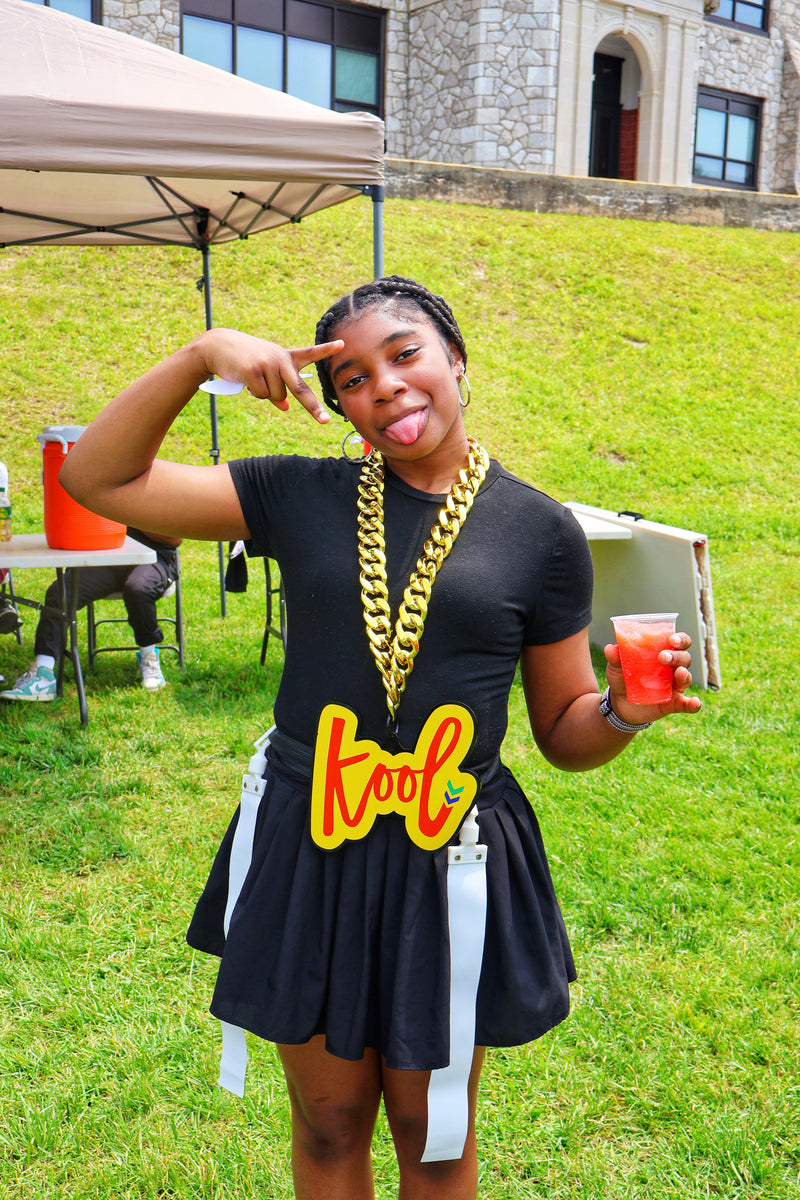 girl throws up peace sign with tongue out with kool chain